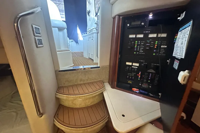 Slide: The Image of 2004 Sea Ray 420 Sundancer interior with control panel and wooden steps. - 70