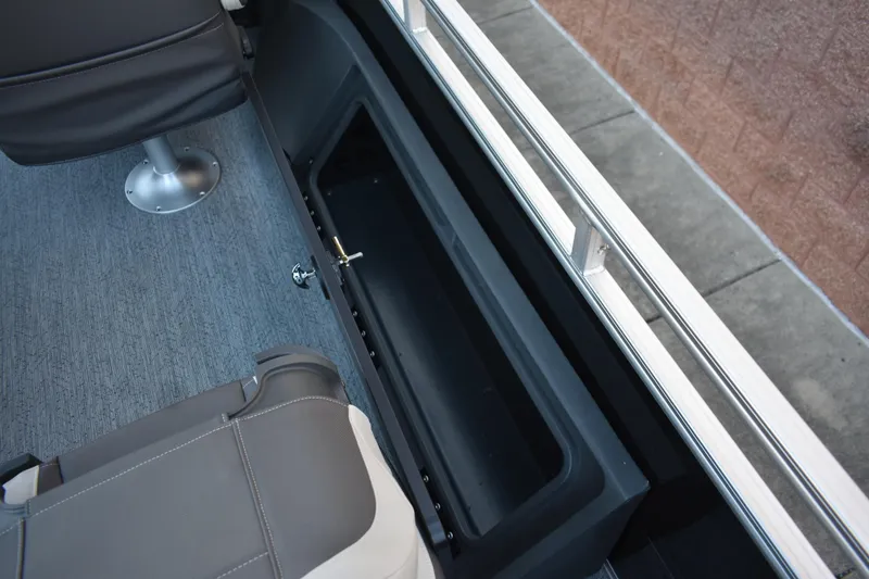 Slide: The Image of 2026 Sun Tracker Fishin' Barge 22 DLX interior storage compartment and seating detail. - 14