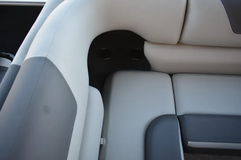 Slide: The Image of 2026 Sun Tracker Fishin' Barge 22 DLX interior seating detail, featuring gray and white upholstery. - 15