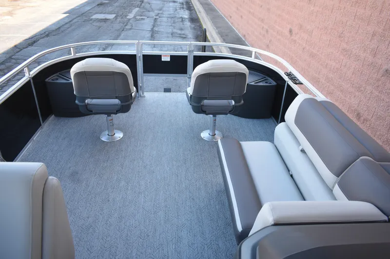 Slide: The Image of 2026 Sun Tracker Fishin' Barge 22 DLX interior with seating and carpeted deck. - 16