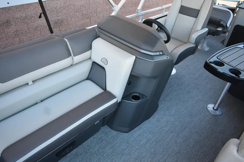 Slide: The Image of 2026 Sun Tracker Fishin' Barge 22 DLX interior with seating and steering console. - 17