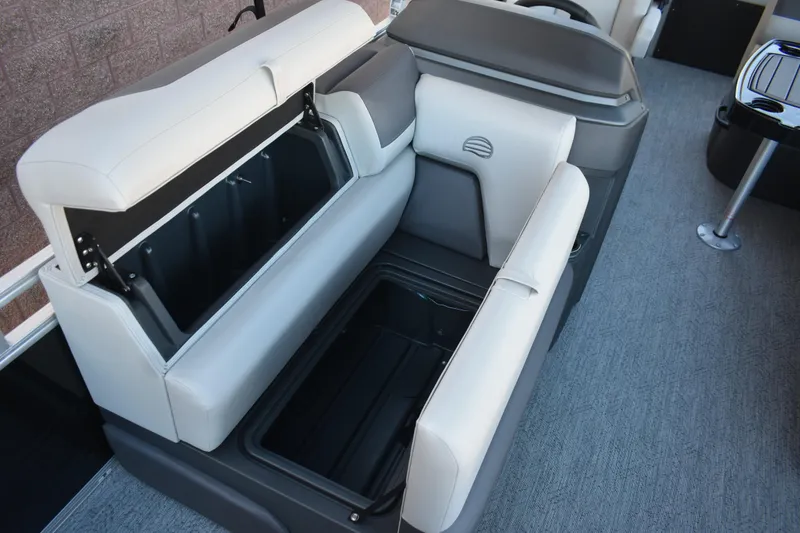 Slide: The Image of 2026 Sun Tracker Fishin' Barge 22 DLX interior seating with storage compartments. - 18