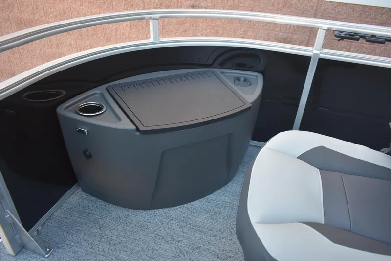 Slide: The Image of 2026 Sun Tracker Fishin' Barge 22 DLX interior with seating and storage area. - 19