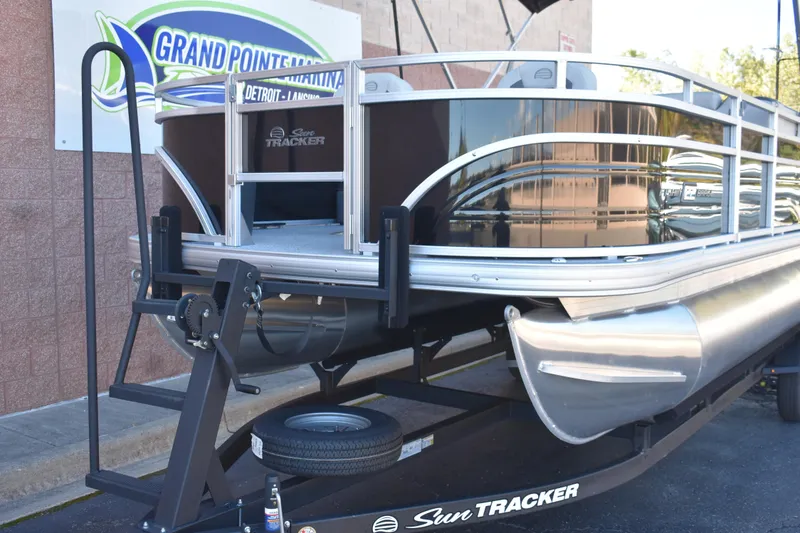 Slide: The Image of 2026 Sun Tracker Fishin' Barge 22 DLX pontoon boat at Grand Pointe Marina. - 2