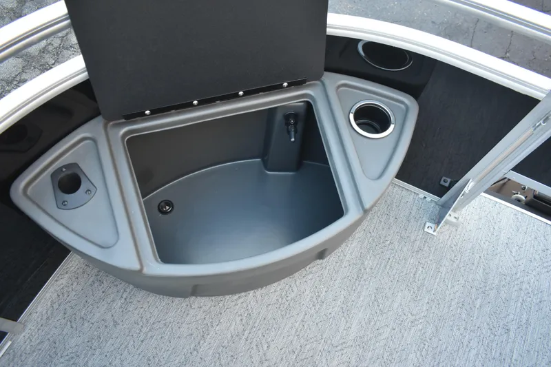 Slide: The Image of 2026 Sun Tracker Fishin' Barge 22 DLX livewell with cup holders and storage compartments. - 21