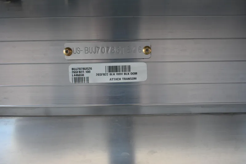 Slide: The Image of 2026 Sun Tracker Fishin' Barge 22 DLX identification plate with serial number and barcode. - 23