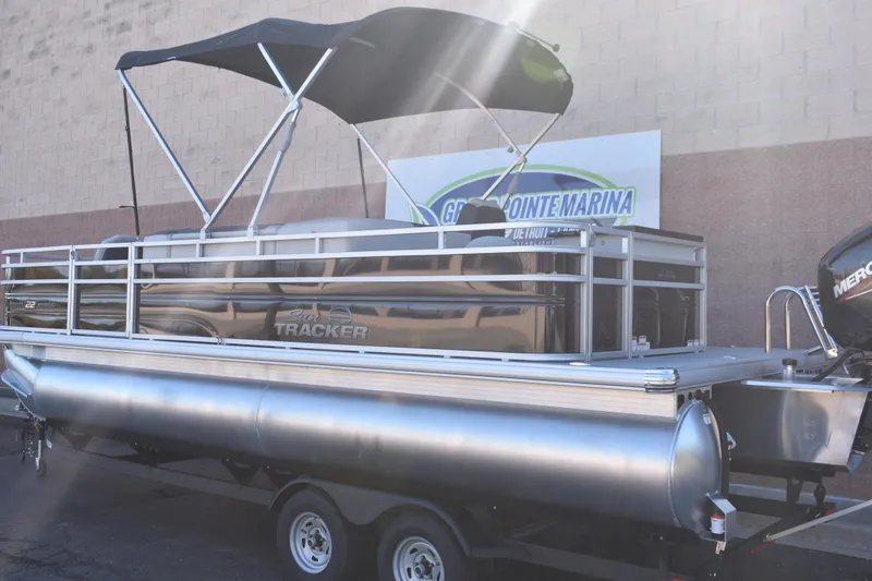 Slide: The Image of 2026 Sun Tracker Fishin' Barge 22 DLX pontoon boat with canopy at marina. - 3