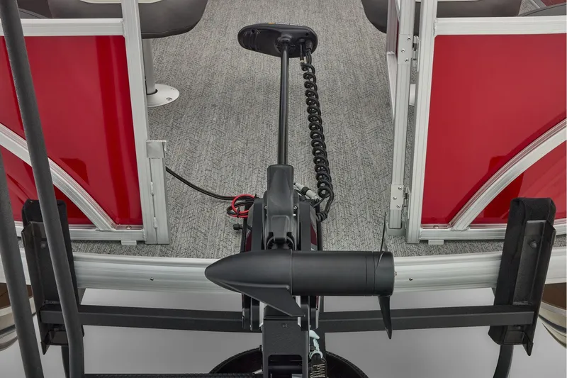 Slide: The Image of Manufacturer Provided Image: 2026 Sun Tracker Fishin' Barge 22 DLX interior with red panels and trolling motor. - 46