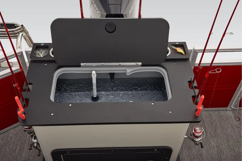 Slide: The Image of Manufacturer Provided Image: 2026 Sun Tracker Fishin' Barge 22 DLX livewell with fishing rods and tackle setup. - 76