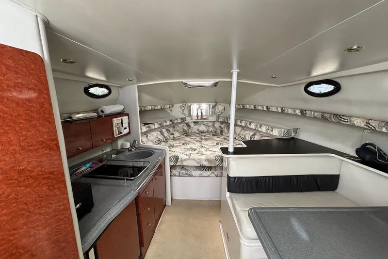 Slide: The Image of Interior of 2002 Wellcraft 330 Coastal boat with kitchenette and cozy sleeping area. - 10