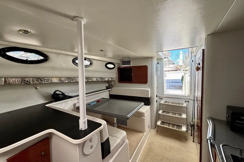 Slide: The Image of Interior of 2002 Wellcraft 330 Coastal boat, featuring seating and compact design. - 13