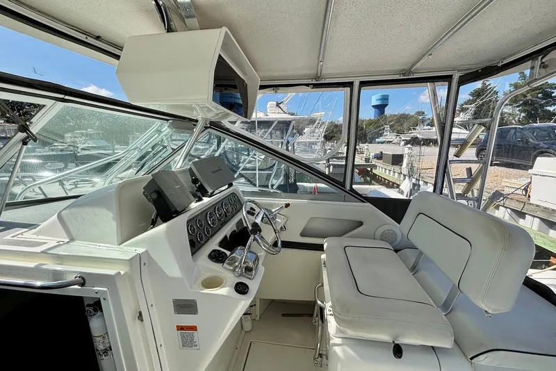 Slide: The Image of 2002 Wellcraft 330 Coastal boat cockpit with steering wheel and navigation equipment. - 3