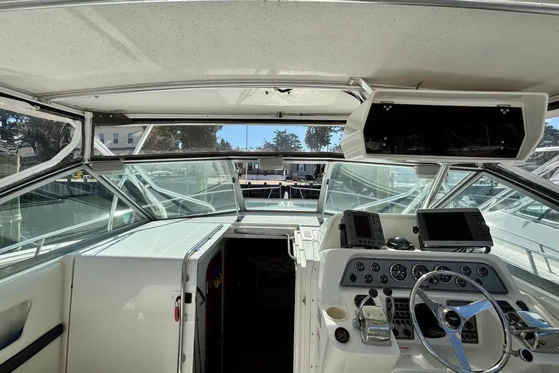 Slide: The Image of 2002 Wellcraft 330 Coastal boat cockpit with steering wheel and navigation equipment. - 5