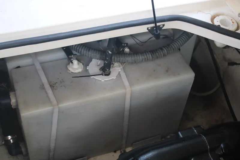 Slide: The Image of 2011 Larson Carbiro 240 boat engine compartment with visible fuel tank and hoses. - 10