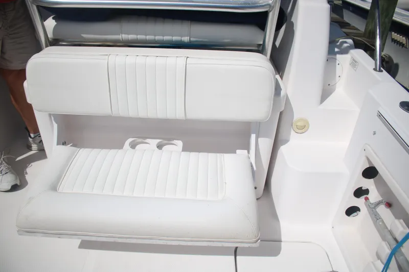 Slide: The Image of White seating area on a 2011 Larson Carbiro 240 boat with cup holders. - 12