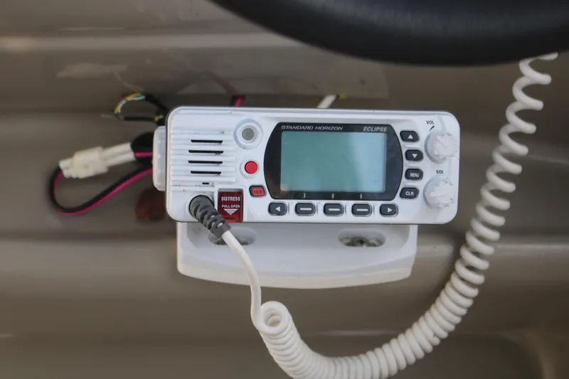 Slide: The Image of VHF marine radio on 2011 Larson Carbiro 240 boat dashboard. - 13