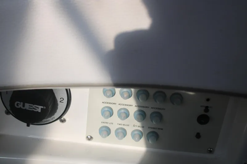 Slide: The Image of Control panel of a 2011 Larson Carbiro 240 boat with accessory switches. - 15