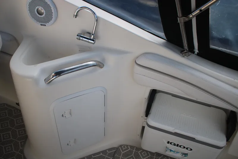 Slide: The Image of Interior of 2011 Larson Cabrio 240 boat with sink, speaker, and Igloo cooler. - 16