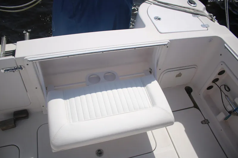 Slide: The Image of White seating area on a 2011 Larson Carbiro 240 boat deck. - 18