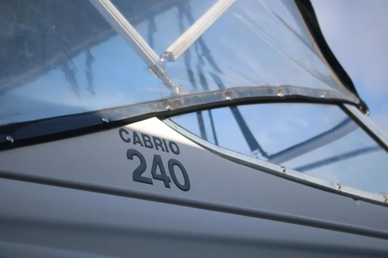 Slide: The Image of 2011 Larson Cabrio 240 boat with clear canopy and sleek design. - 20