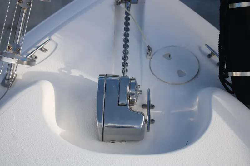 Slide: The Image of Anchor windlass on 2011 Larson Carbiro 240 boat deck, featuring stainless steel components. - 22