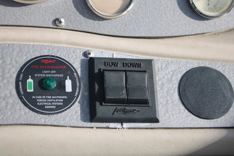 Slide: The Image of Control panel of a 2011 Larson Carbiro 240 boat with fire extinguisher indicator. - 24