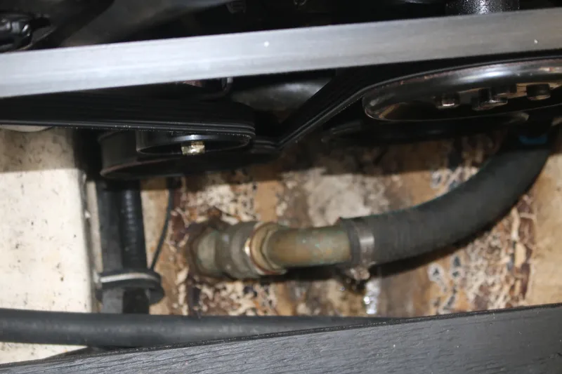 Slide: The Image of Engine compartment of 2011 Larson Carbiro 240 boat showing belts and hoses. - 27