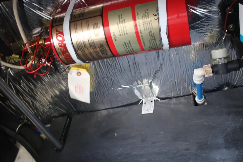 Slide: The Image of Engine compartment of 2011 Larson Carbiro 240 with fire extinguisher and wiring. - 28