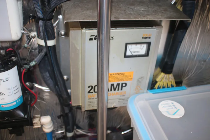 Slide: The Image of Battery charger setup in a 2011 Larson Carbiro 240 boat engine compartment. - 29