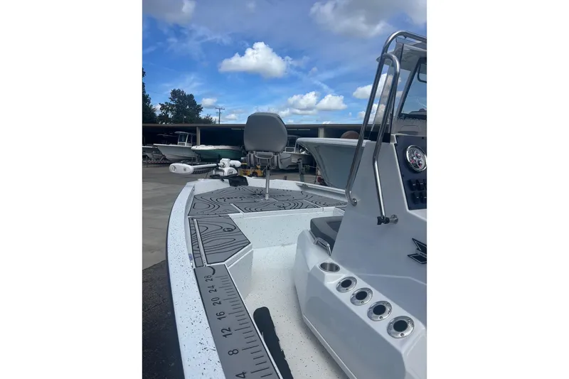 Slide: The Image of 2024 Xpress H20B Bay boat with sleek design and modern features under a blue sky. - 3