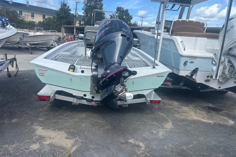 Slide: The Image of 2024 Xpress H20B Bay boat with Yamaha outboard motor on trailer. - 7