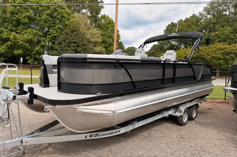 Slide: The Image of 2026 Veranda VR 265 VLI pontoon boat on EZ Loader trailer, parked outdoors. - 3