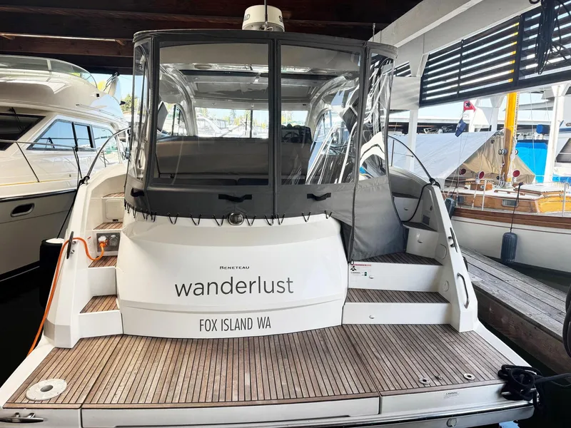 Slide: The Image of 2015 Beneteau Gran Turismo 44 yacht docked, rear view with "Wanderlust" name visible. - 24