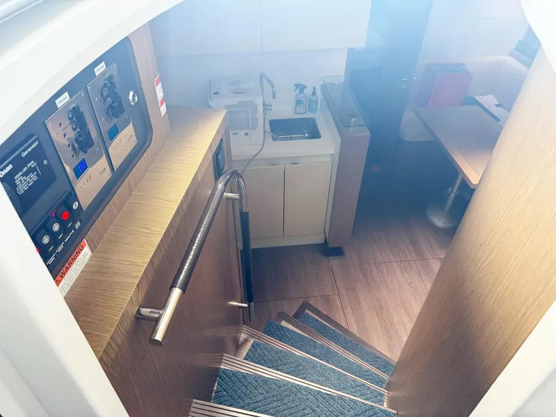 Slide: The Image of Interior view of 2015 Beneteau Gran Turismo 44 yacht, featuring stairs and a compact kitchen area. - 3