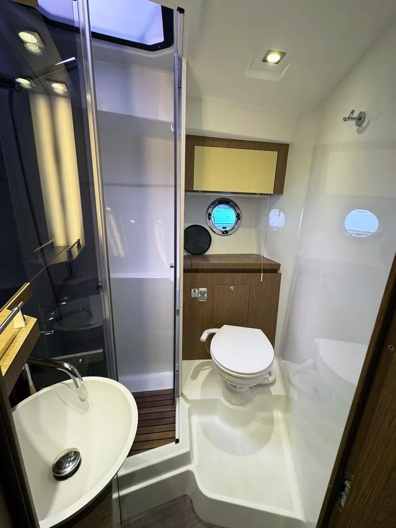 Slide: The Image of 2015 Beneteau Gran Turismo 44 yacht bathroom with modern fixtures and porthole window. - 8