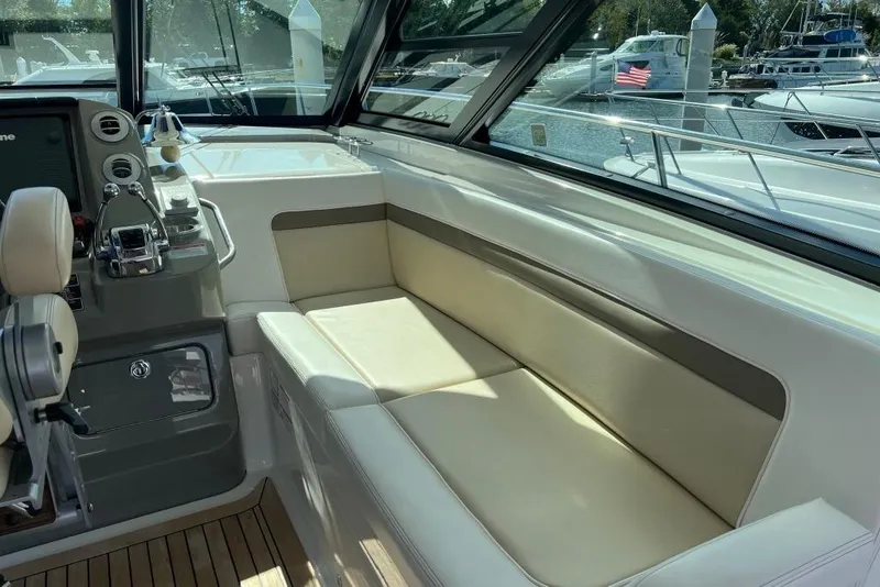 Slide: The Image of 2013 Sea Ray 540 Sundancer yacht cruising near a bridge at sunset. - 10