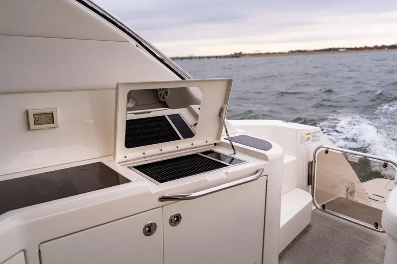 Slide: The Image of Outdoor grill on 2013 Sea Ray 540 Sundancer yacht, cruising on open water. - 40