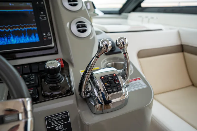 Slide: The Image of Control panel of 2013 Sea Ray 540 Sundancer yacht with dual throttle levers. - 44