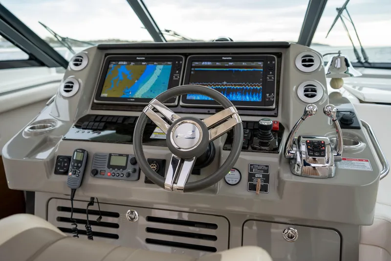 Slide: The Image of Control panel of 2013 Sea Ray 540 Sundancer yacht with navigation screens and steering wheel. - 45