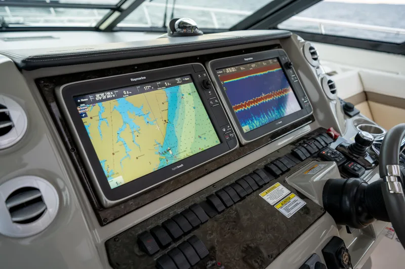 Slide: The Image of Dashboard of a 2013 Sea Ray 540 Sundancer with navigation screens and controls. - 46