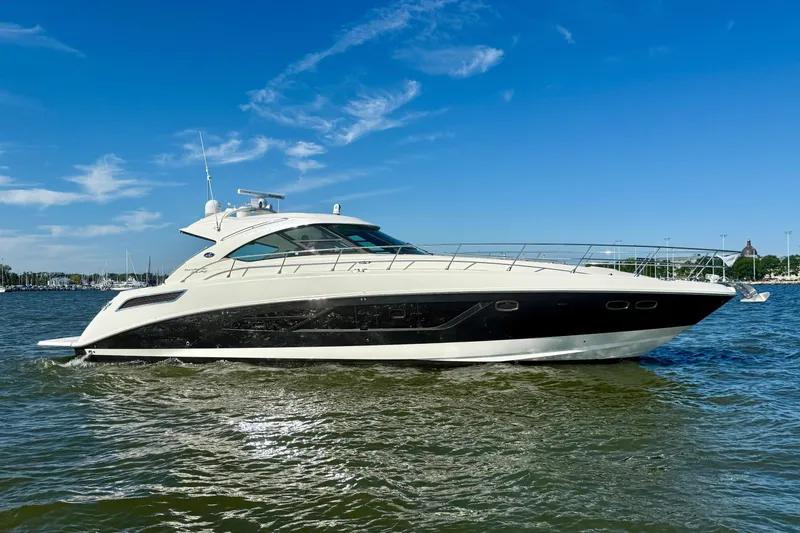 Slide: The Image of 2013 Sea Ray 540 Sundancer cruising on open water at sunset. - 6