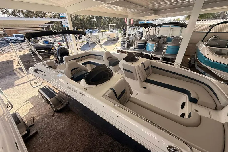 The Image of 2026 Hurricane Sundeck Sport 218 OB boat displayed in a showroom. - 0