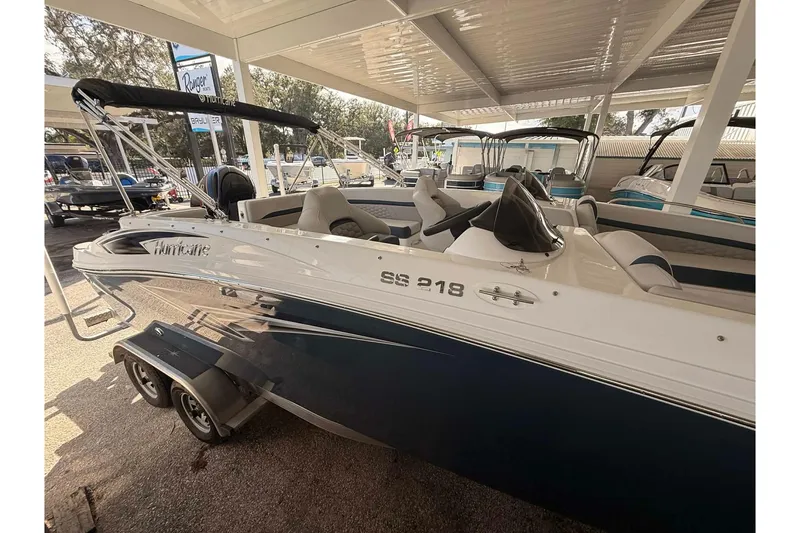 Slide: The Image of 2026 Hurricane Sundeck Sport 218 OB boat displayed in a showroom. - 1