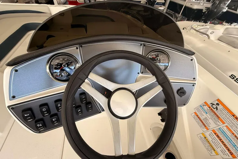 Slide: The Image of 2026 Hurricane Sundeck Sport 218 OB dashboard with steering wheel and gauges. - 5