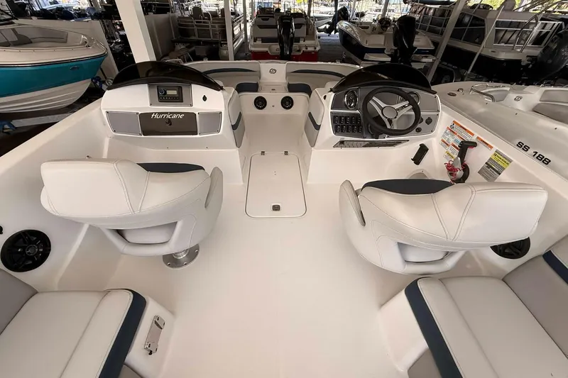 Slide: The Image of 2026 Hurricane Sundeck Sport 218 OB boat interior with dual captain seats and control panel. - 8