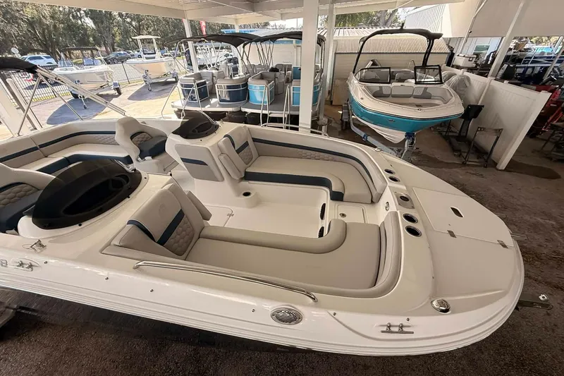 Slide: The Image of 2026 Hurricane Sundeck Sport 218 OB boat in showroom, featuring spacious seating and modern design. - 9