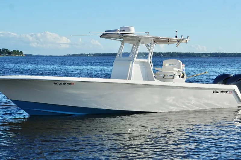 The Image of 2023 Contender 30 Tournament boat on calm blue water under clear sky. - 0