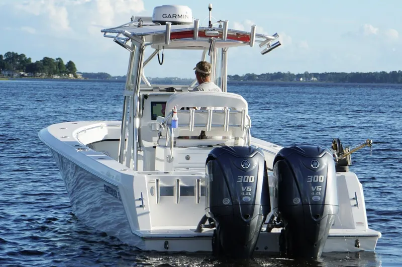 Slide: The Image of 2023 Contender 30 Tournament boat with dual Yamaha engines on open water. - 11