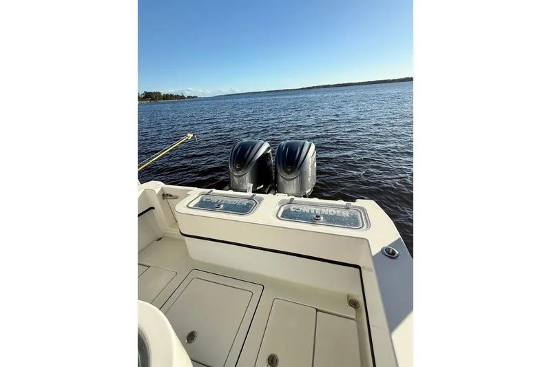Slide: The Image of 2023 Contender 30 Tournament boat with dual engines on open water. - 16