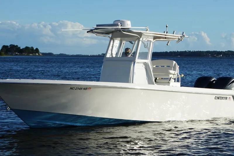 Slide: The Image of 2023 Contender 30 Tournament boat cruising on a sunny day. - 2